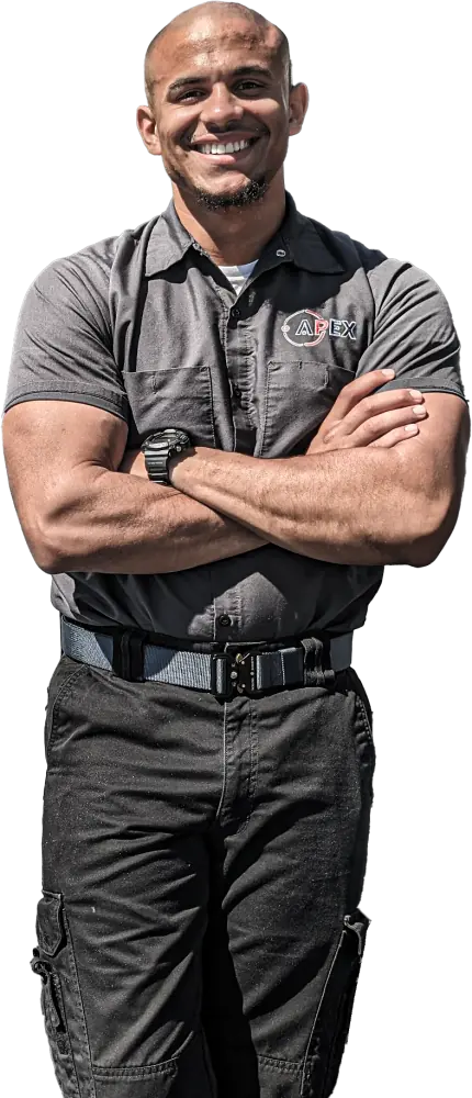 An Apex team member in uniform, arms crossed and smiling